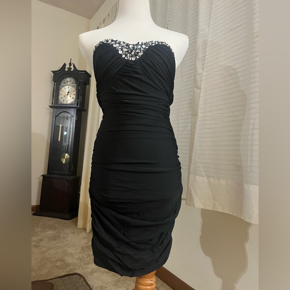 This is a brand new black beaded knee length formal dress